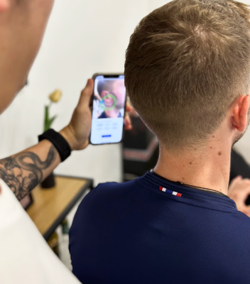 The Adapto Scan app is shown as it is scanning a man's ear